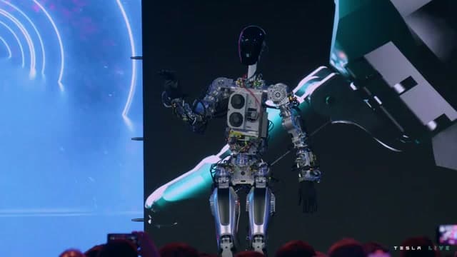 Tesla Optimus Gen 1 Bumblebee prototype standing onstage at AI Day 2022